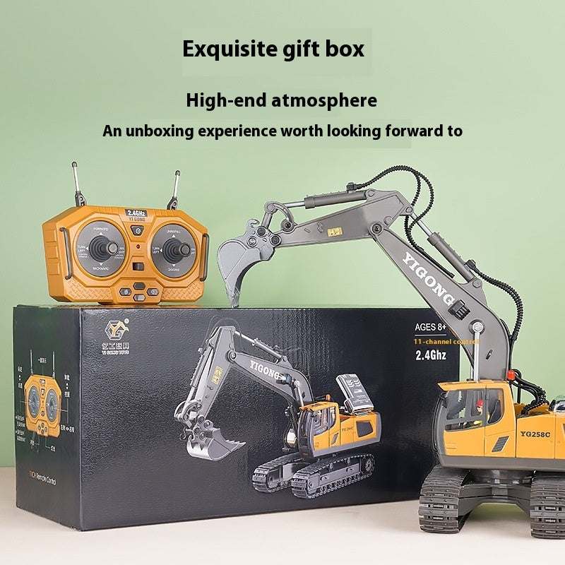 Remote-control engineering car toy with orange controller and realistic digging arm on black gift box