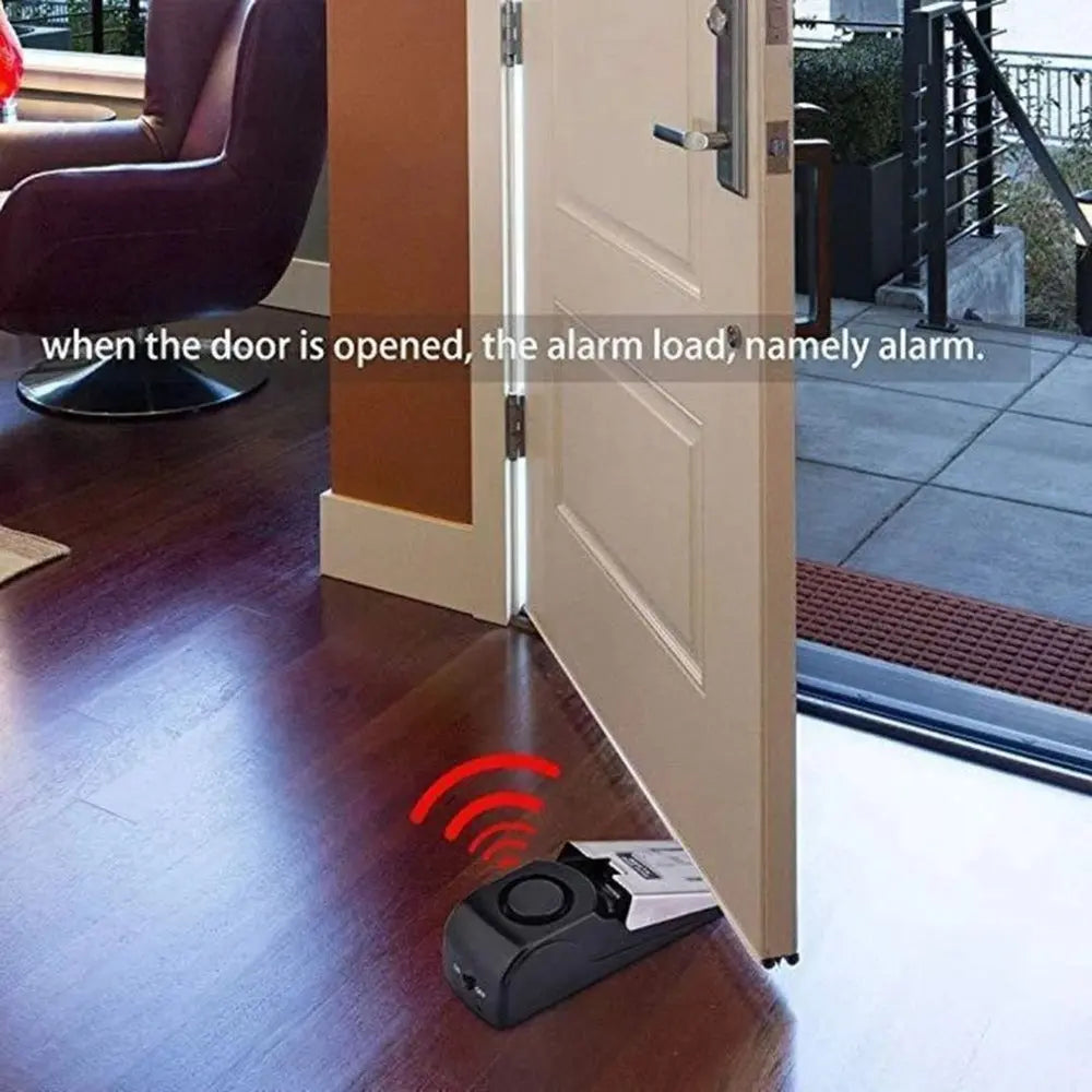 Electronic door stop alarm placed under door triggering loud 150dB siren for home security.
