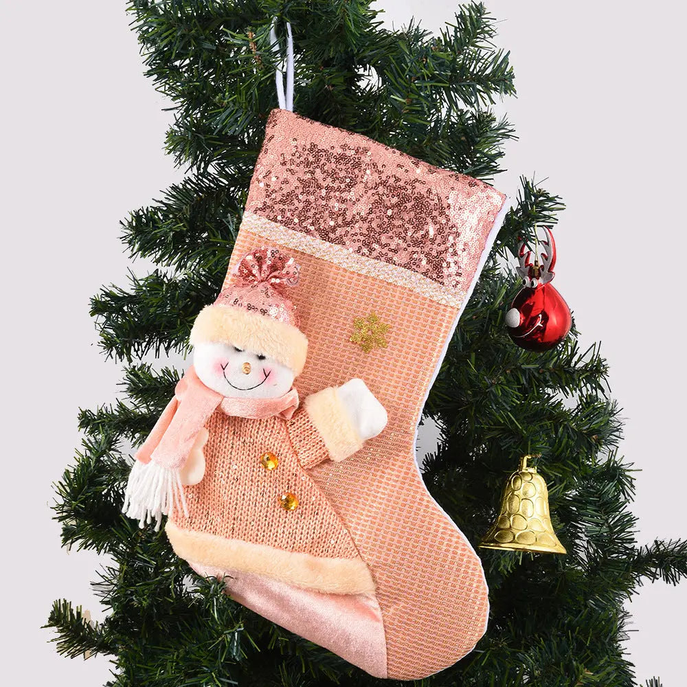Handmade sequined Christmas stocking with snowman design hanging on Christmas tree