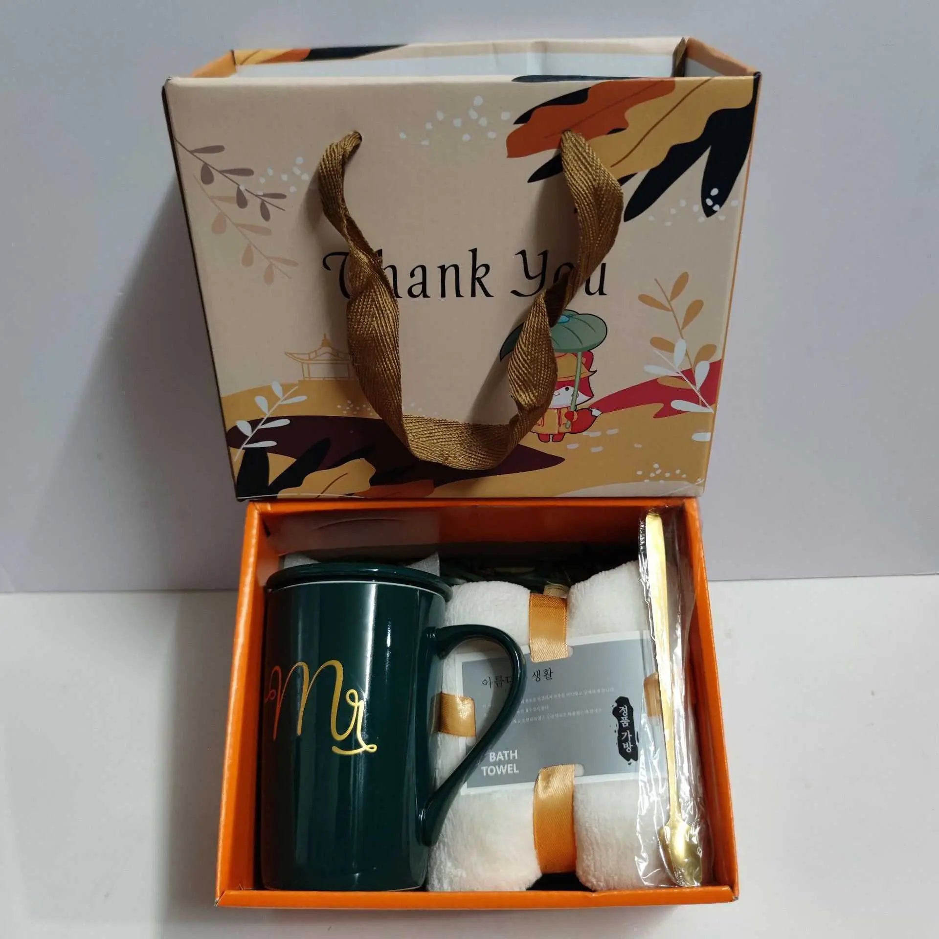 Ceramic cup gift box set with green letter print mug, white towel, gold spoon, and decorative gift bag