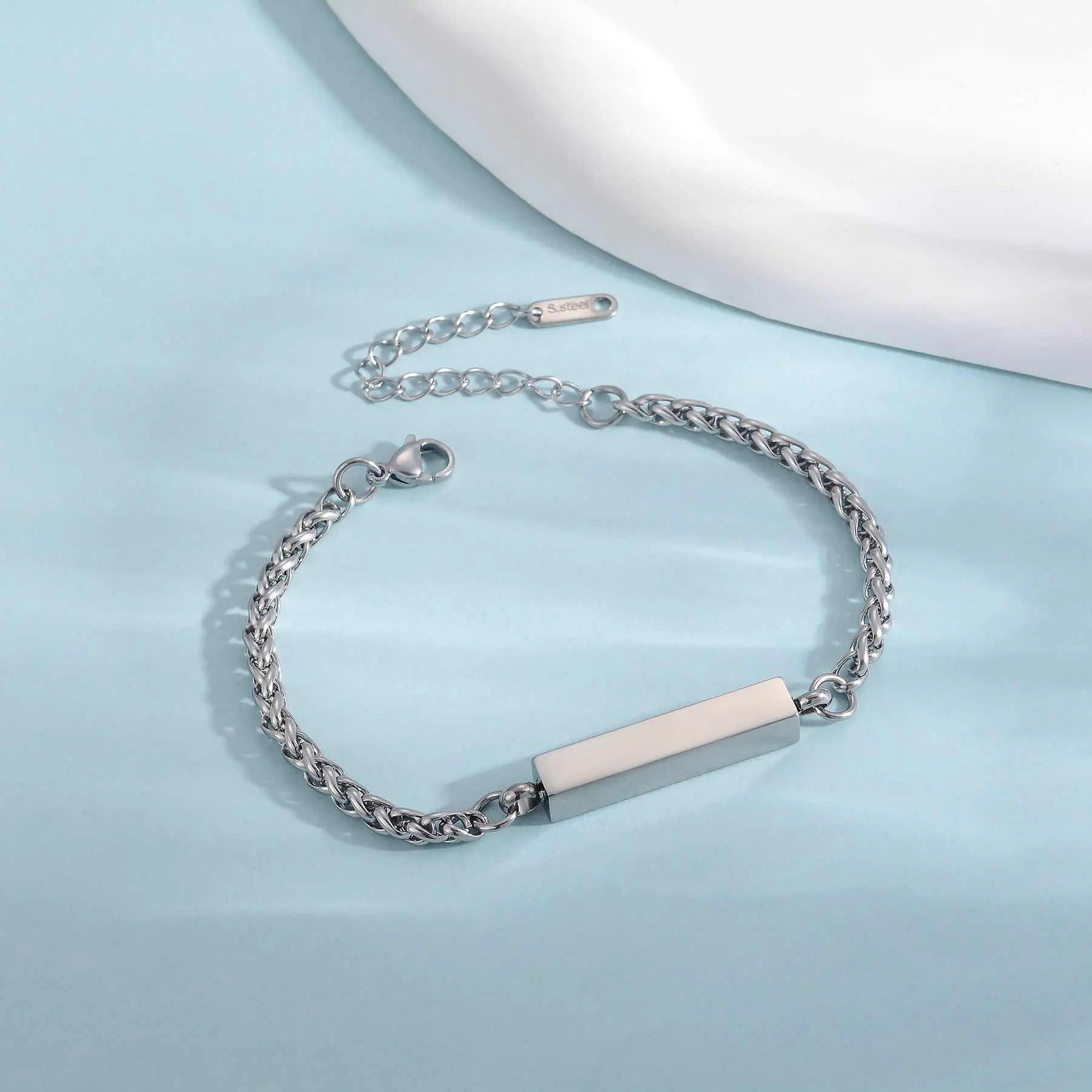 Unisex stainless steel rectangular column bracelet with adjustable chain on blue background
