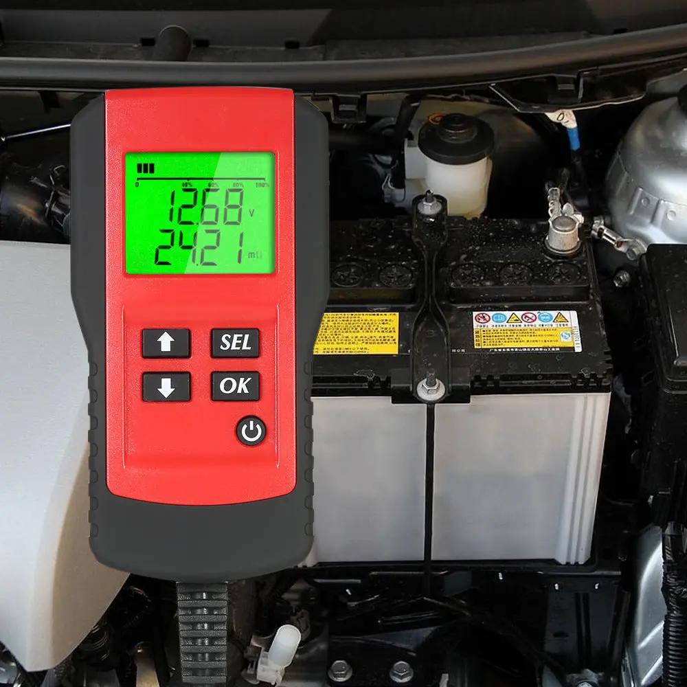 Digital battery tester on a car battery with readings displayed