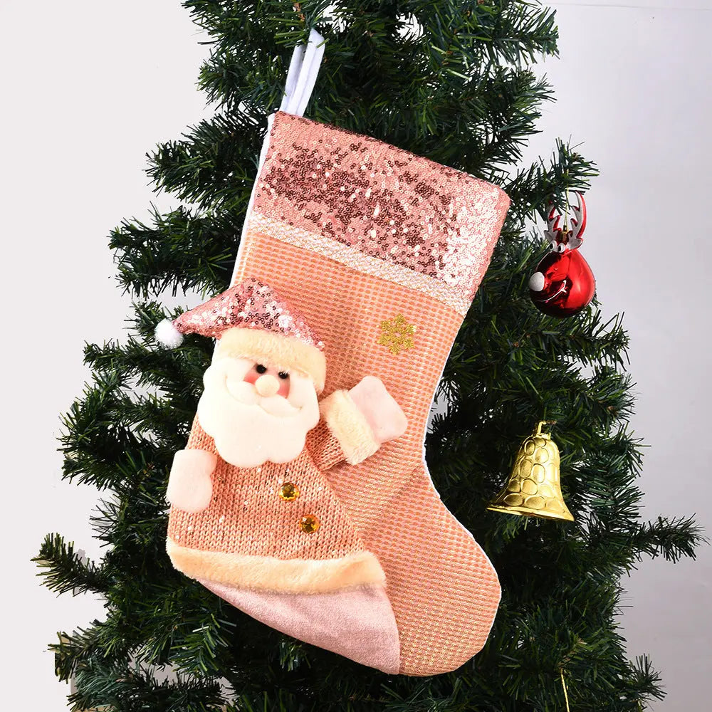 Handmade sequined Christmas stocking with Santa design hanging on Christmas tree decoration
