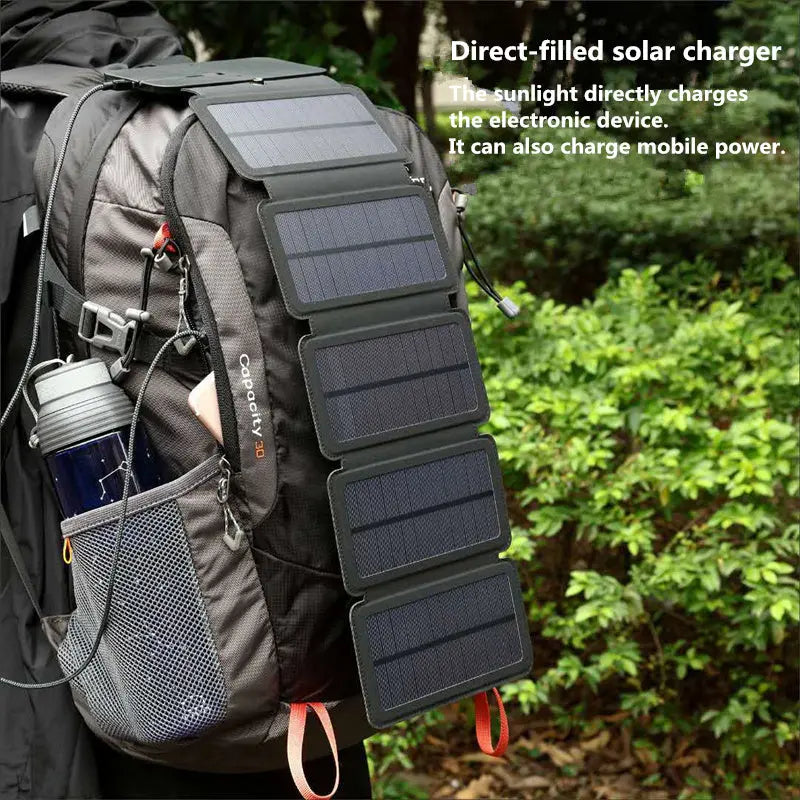 Outdoor folding solar panel charger attached to backpack in a forest setting