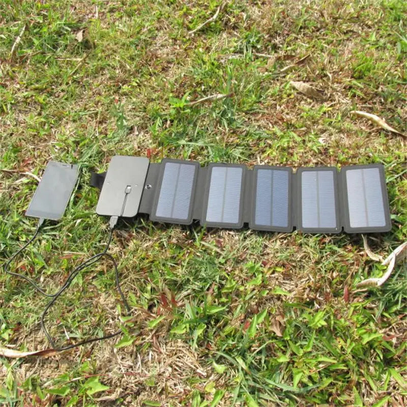 Outdoor folding solar panel charger with 7.2W to 9W power, USB output, and portable design on grass