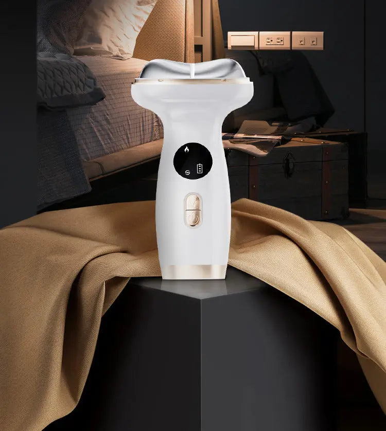 White handheld steamer on a dark surface with a blurred background