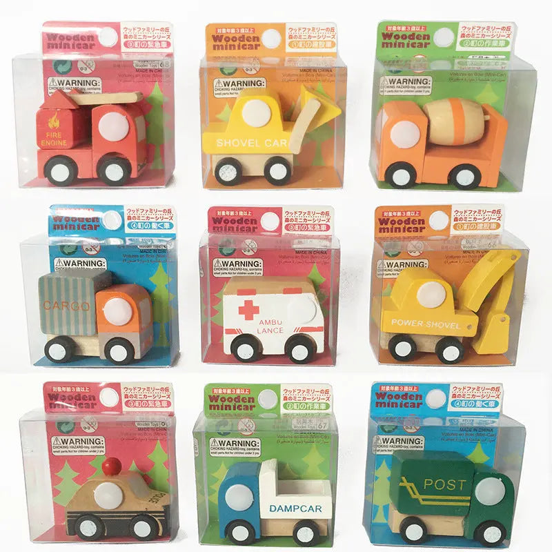 Set of wooden toy vehicles in packaging on a white background