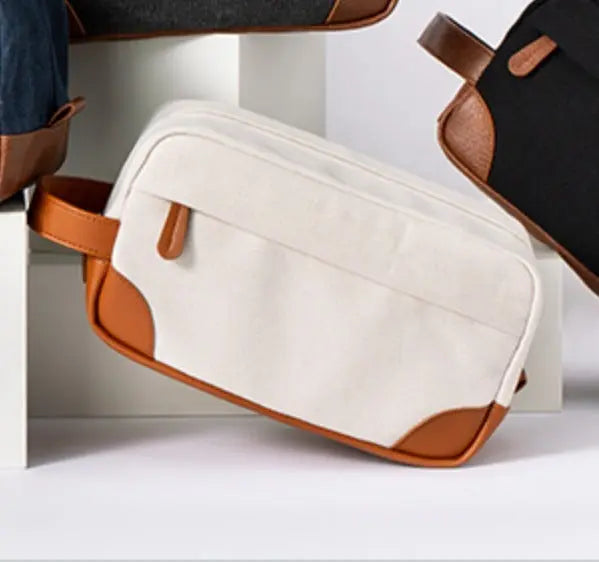 Men's toiletry large capacity travel bag in white canvas with brown leather accents and handle