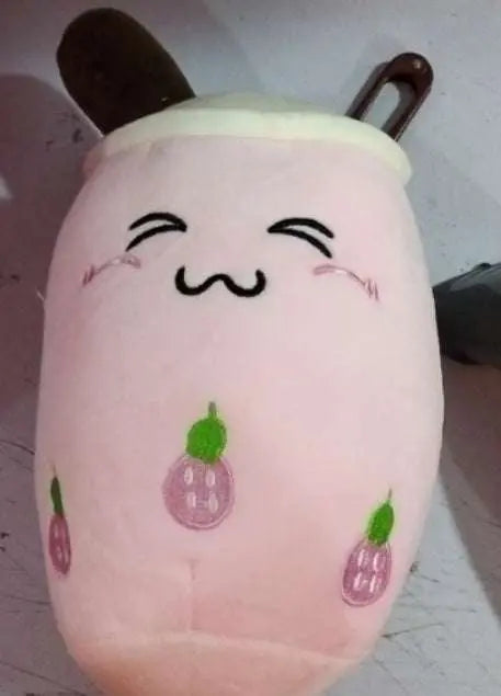 Soft pink plush boba stuffed toy with embroidered cute face and fruit designs
