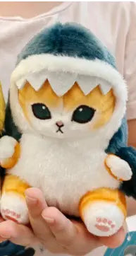 Plush toy resembling a cat with shark fin on a plain background