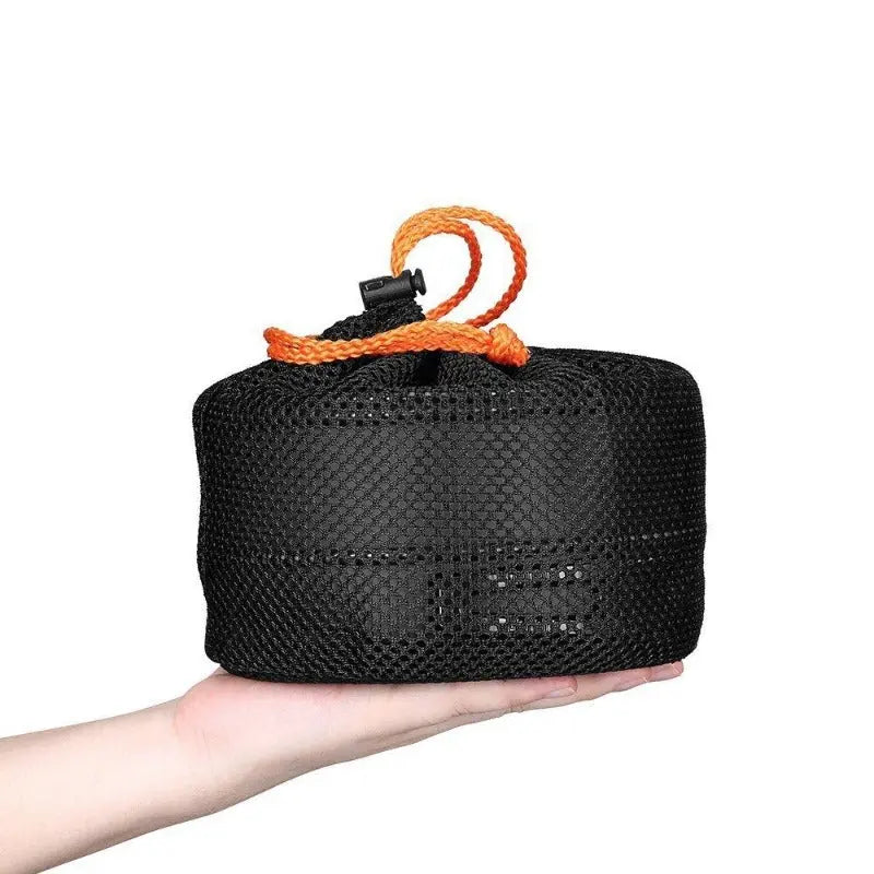 Compact aluminum alloy camping cookware set in black mesh bag with orange drawstring held in hand