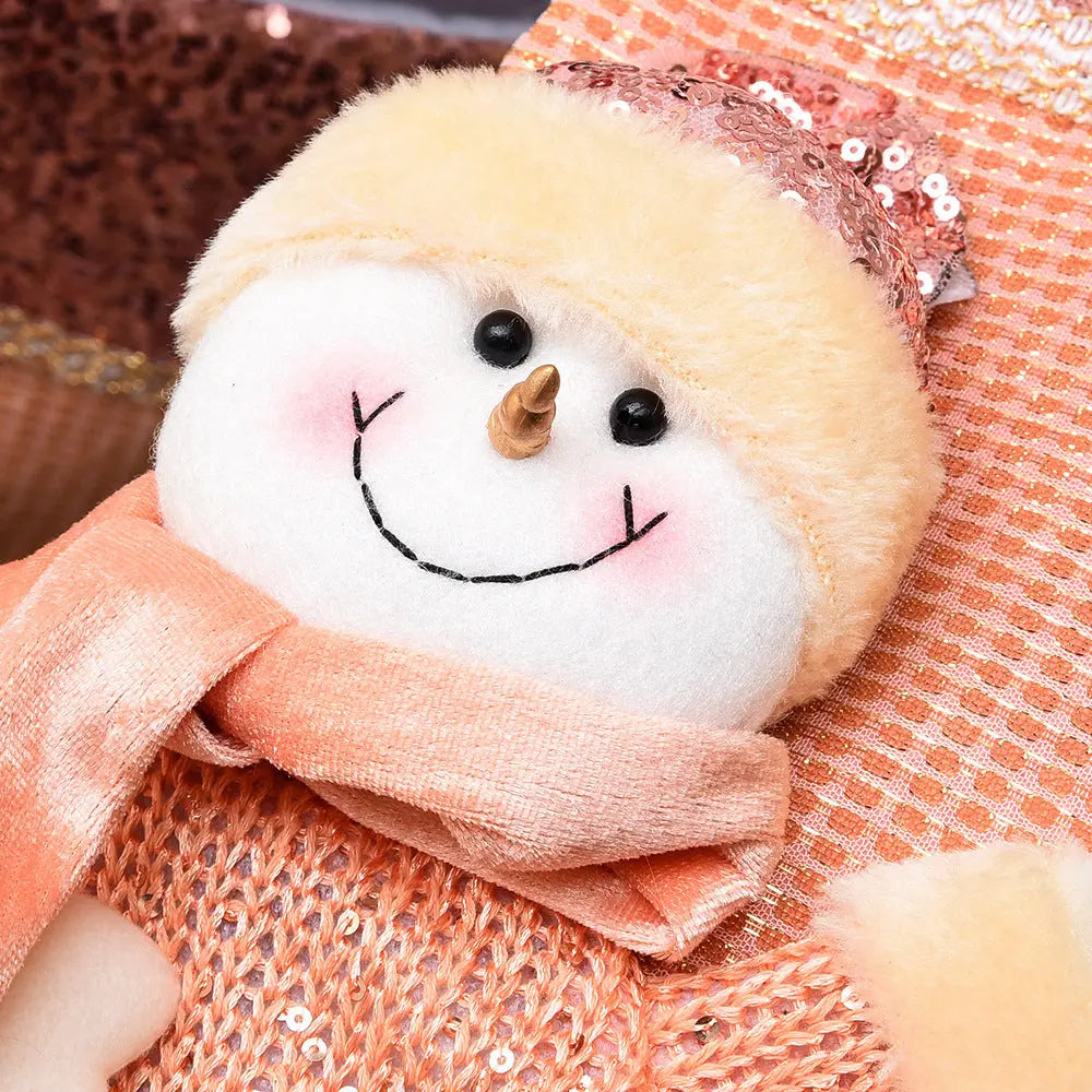 Close-up of a handmade sequined Christmas stocking featuring a smiling snowman with a peach scarf and hat.