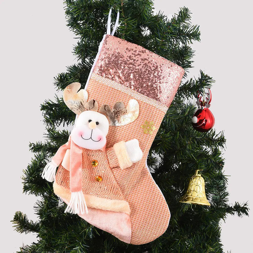 Sequined Christmas stocking with plush reindeer decoration hanging on Christmas tree