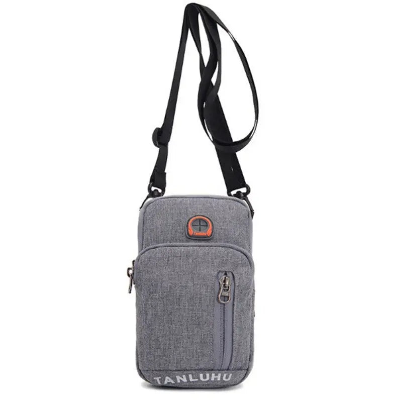 Gray crossbody bag with a strap on a white background