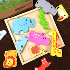 Colorful animal-shaped wooden puzzles in a wooden box on a brown surface.