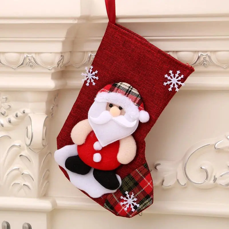 Red Christmas hanging stocking with Santa Claus design and snowflake decorations