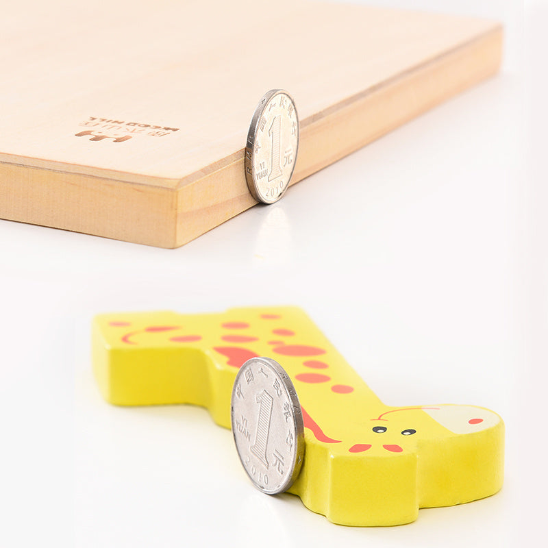 Yellow rubber stamp shaped like a cartoon character with a coin for scale on a light background