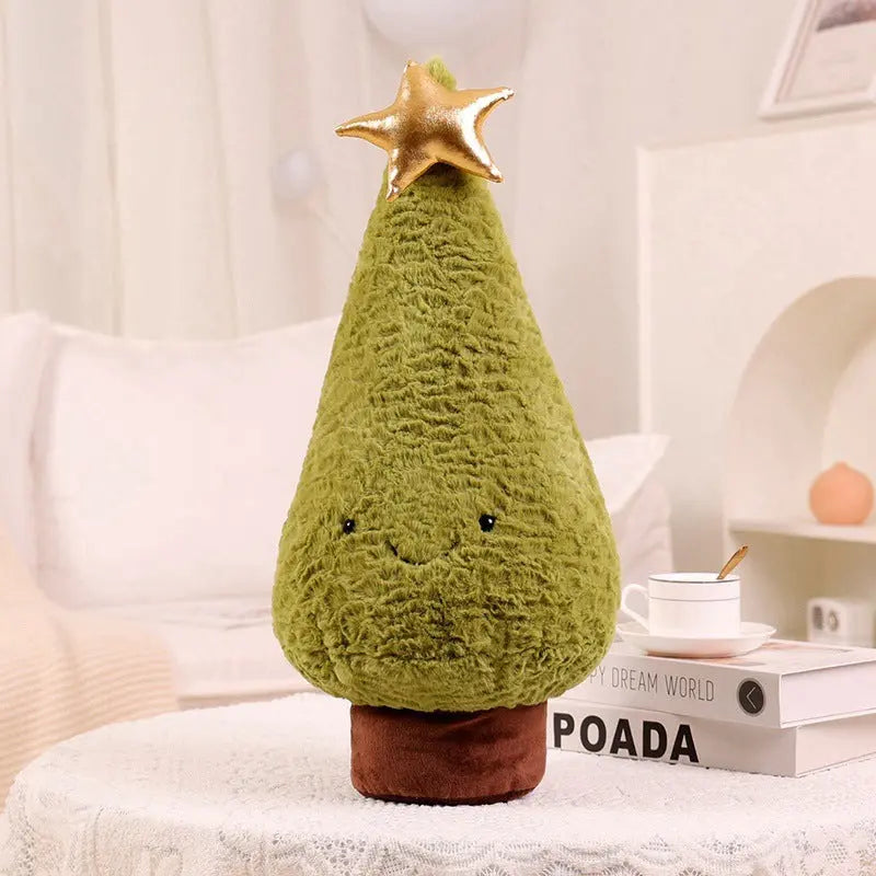 soft plush green Christmas tree pillow with gold star on top on white table