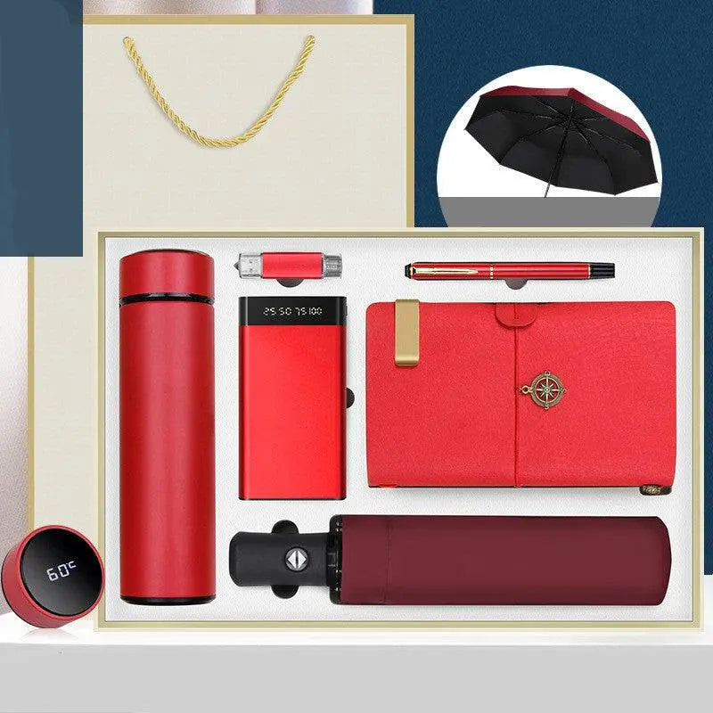 Luxury red Ultimate Gift Box business set with thermos, umbrella, notebook, pen, power bank, USB drive, Bluetooth speaker, and keychain in elegant packaging
