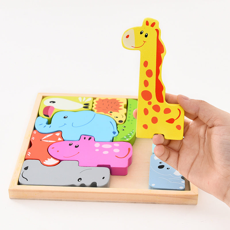 Hand holding a wooden puzzle with animal shapes and a giraffe piece.