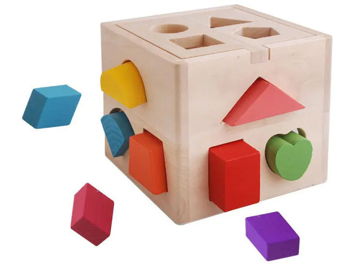 Wooden shape sorting cube with colorful blocks on a white background