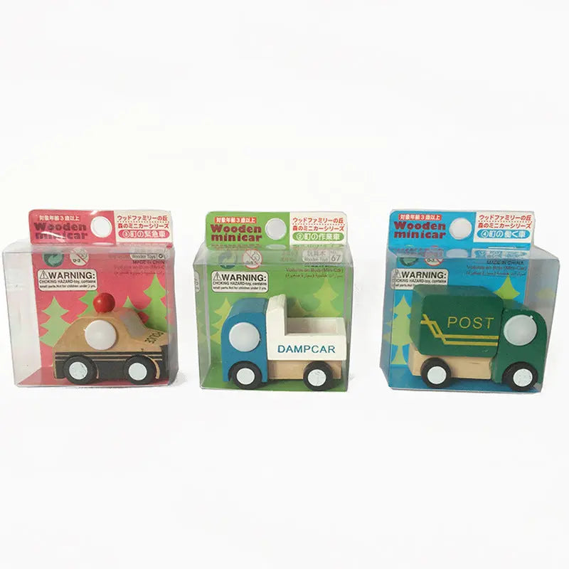 Three wooden toy cars in their packaging on a white background