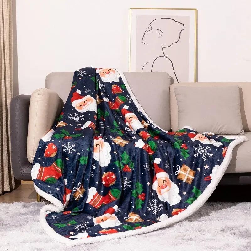 Cozy double-layer flannel Christmas blanket with Santa Claus and holiday prints draped on sofa