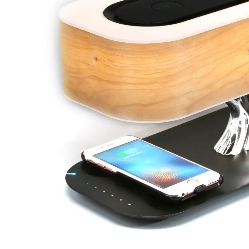 Tree of Life Table Lamp with natural cherry wood finish, built-in Bluetooth speaker, and wireless charging pad with dimmable touch control