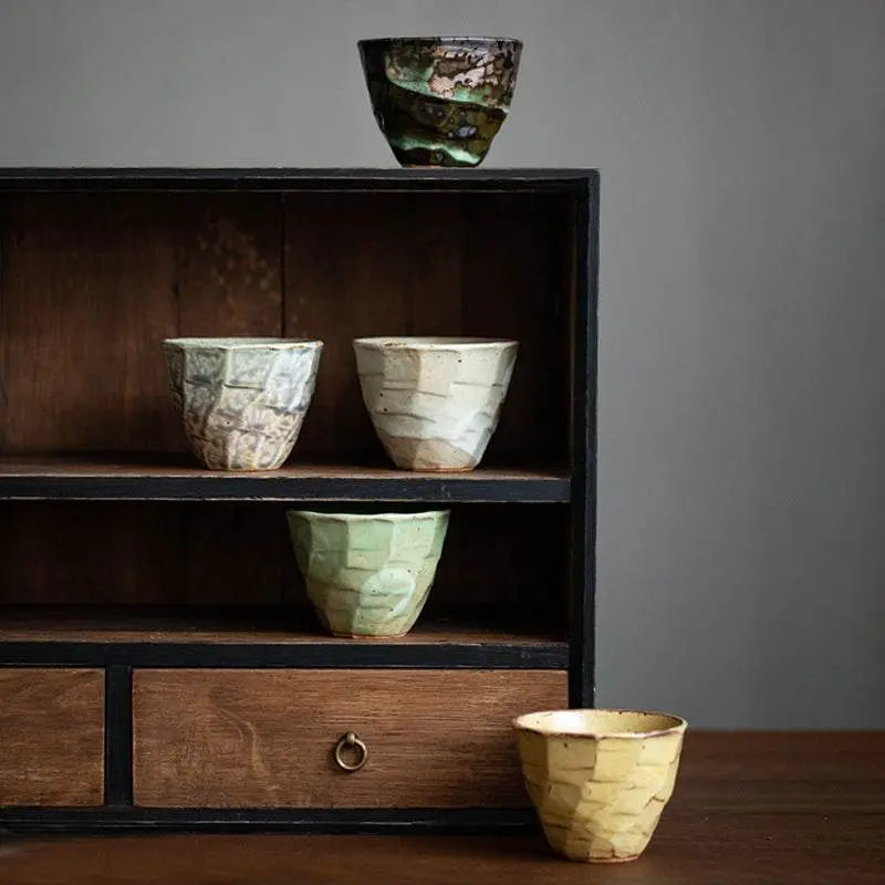 Japanese retro ceramic tea set with five handcrafted Song Jian style bowls in varied earthy tones displayed on a wooden shelf