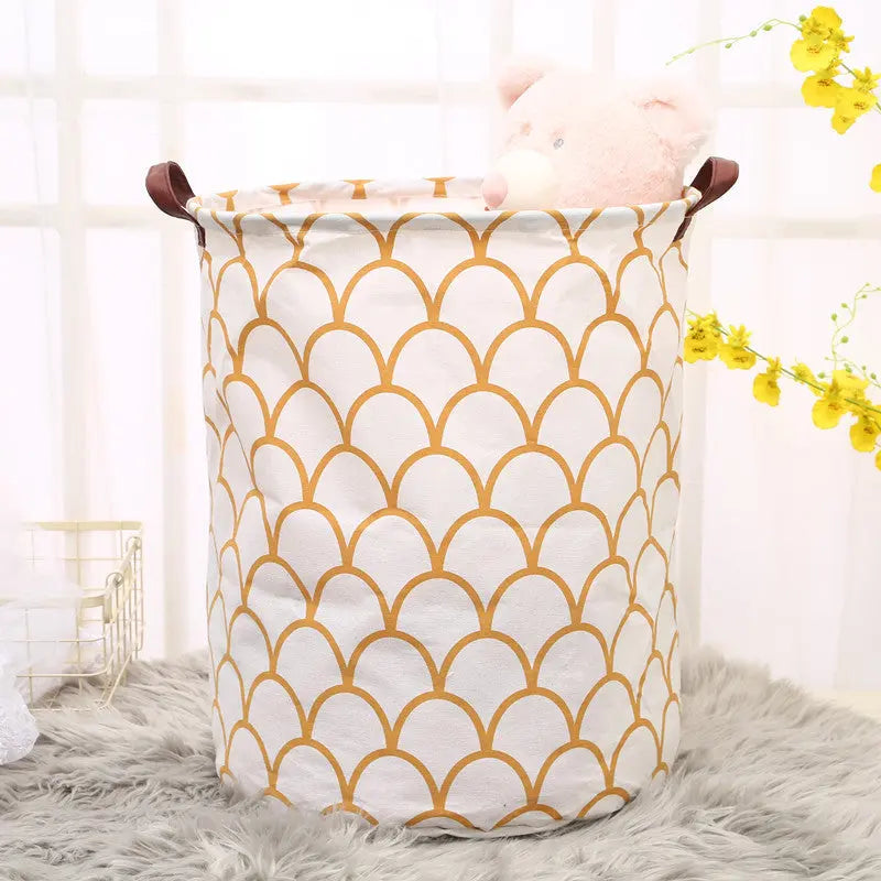 White laundry basket with gold geometric pattern on a fluffy surface with yellow flowers in the background