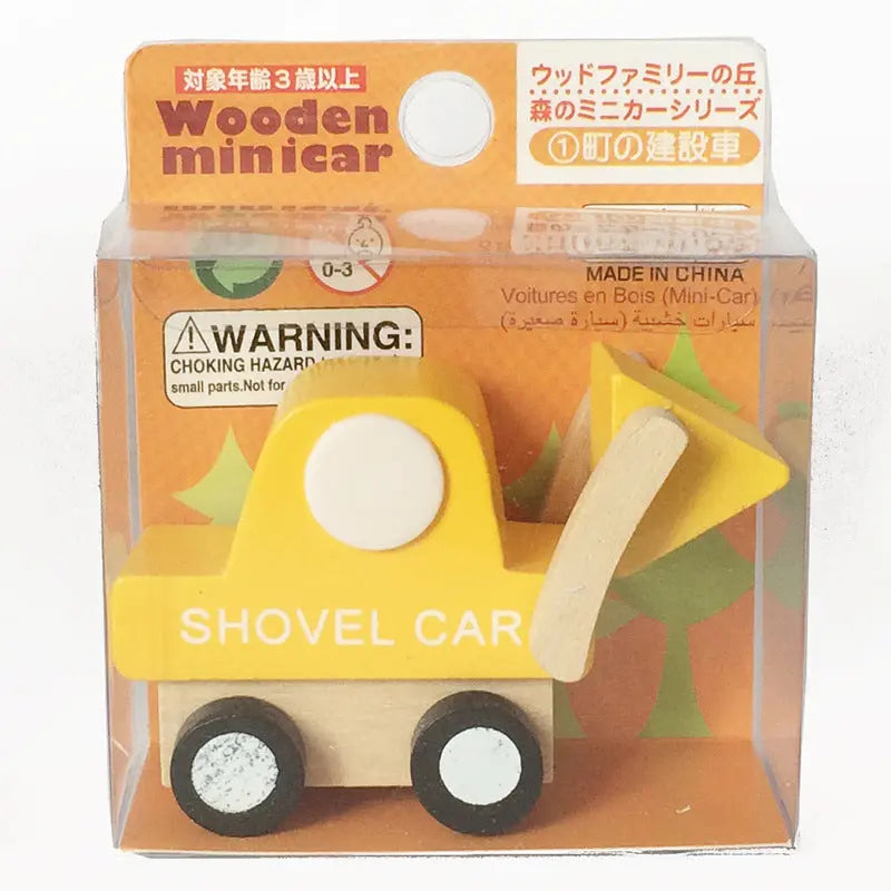 Wooden toy shovel car in packaging with warning label
