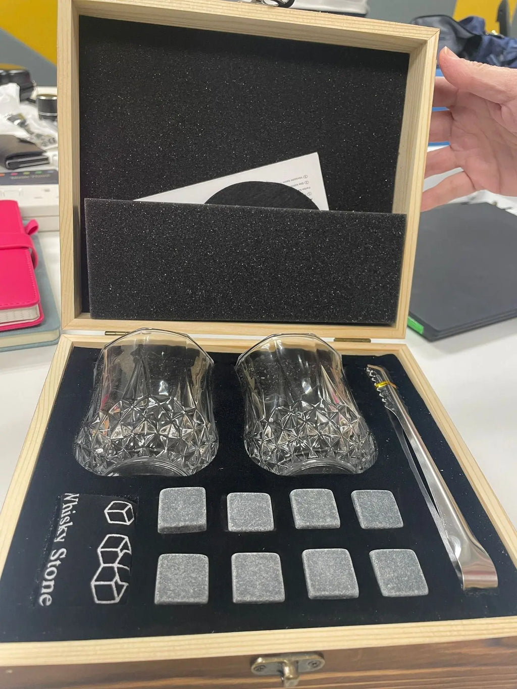 Whisky glasses and granite stones set in wooden gift box with tongs for chilling drinks without dilution