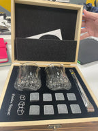 Whisky glasses and granite stones set in wooden gift box with tongs for chilling drinks without dilution