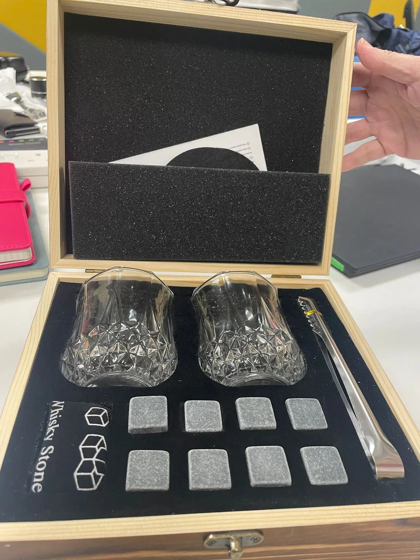 Whisky glasses and granite stones set in wooden gift box with tongs for chilling drinks without dilution