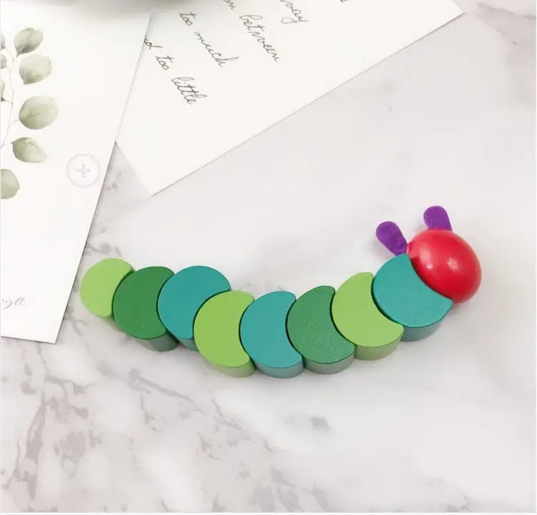 Colorful toy caterpillar on a marble surface
