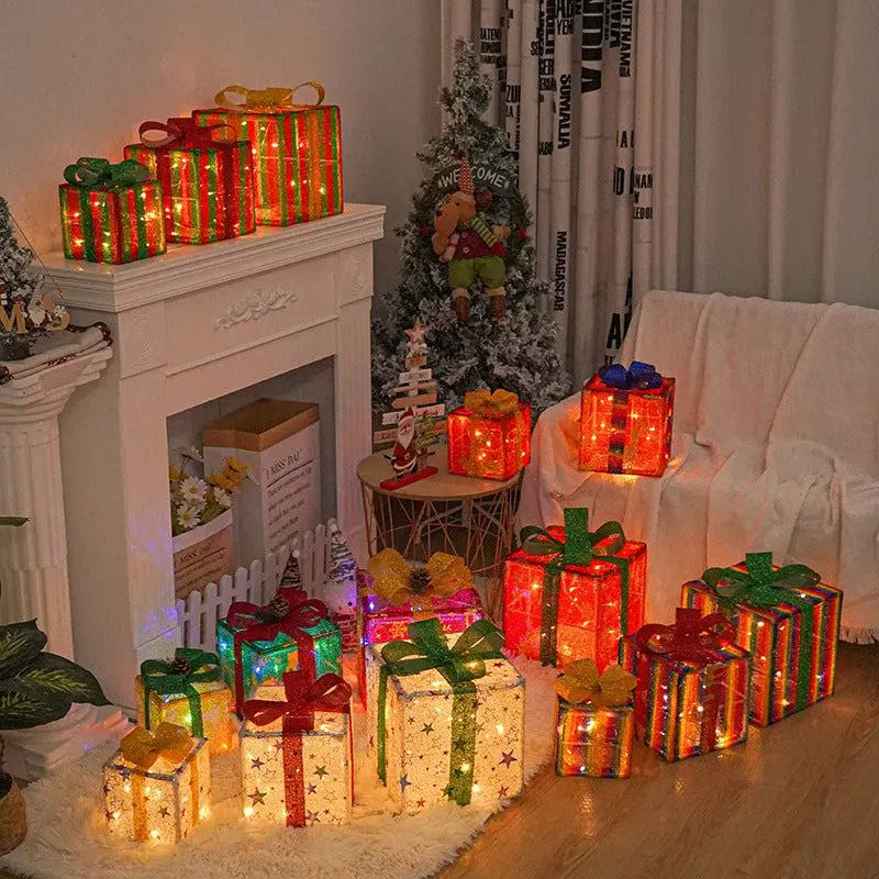 Set of colorful pre-lit Christmas gift boxes with LED lights and decorative bows for indoor holiday decor