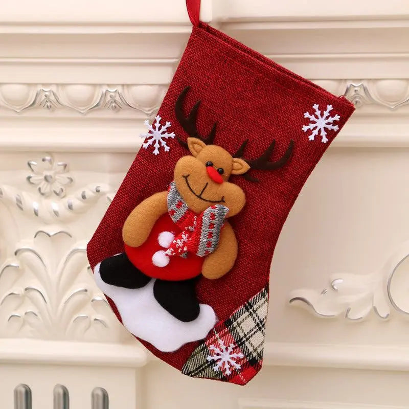 Red Christmas hanging stocking with smiling reindeer and snowflake decorations