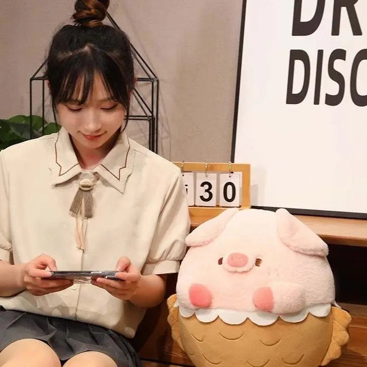 Soft and cuddly Piggy Doll Plush Toy in pink sitting next to a girl playing on a phone