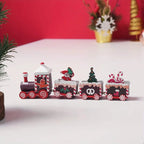 Festive wooden train Christmas decoration with Santa, tree, and candy designs on a white surface