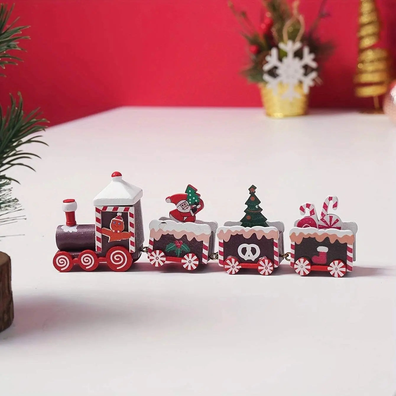 Festive wooden train Christmas decoration with Santa, tree, and candy designs on a white surface