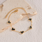 Gold bracelet with black love heart charms on adjustable chain
