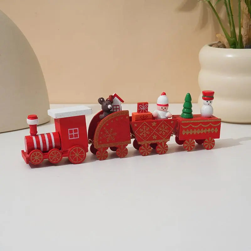 Wooden Train Christmas Decoration with Santa and festive figures in red and green colors on white surface