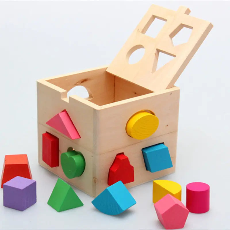 Wooden shape sorting toy with colorful blocks on a light gray background