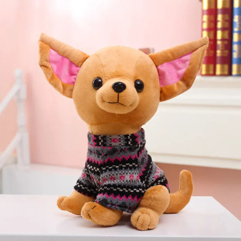 Adorable plush dog doll toy with large ears wearing a patterned sweater sitting on a table