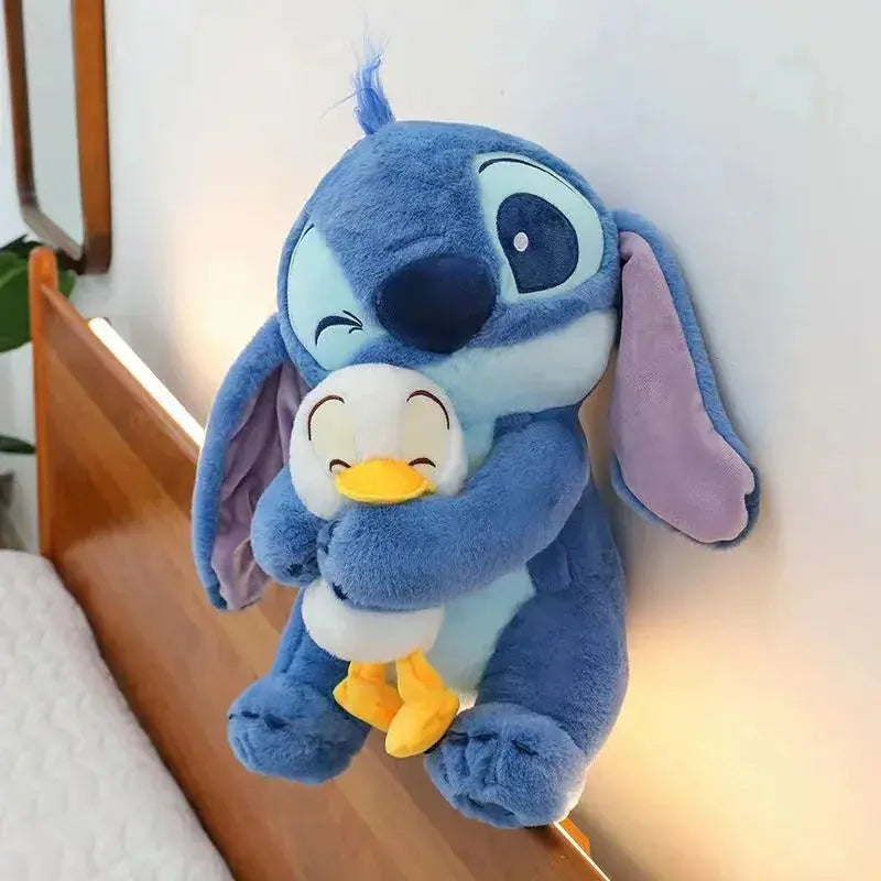 Plush toy resembling a cartoon character with blue fur, white face, and yellow feet on a wooden surface.