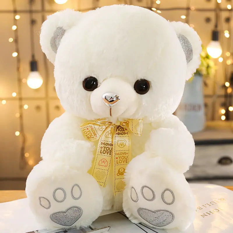 White Huggable Heart Teddy Bear Plush with cute bow and heart paw prints on cozy background