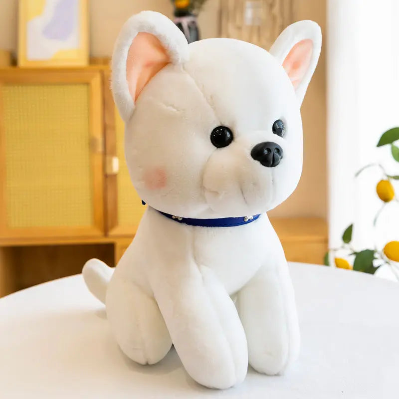 White plush puppy stuffed toy with blue collar sitting on table in cozy room