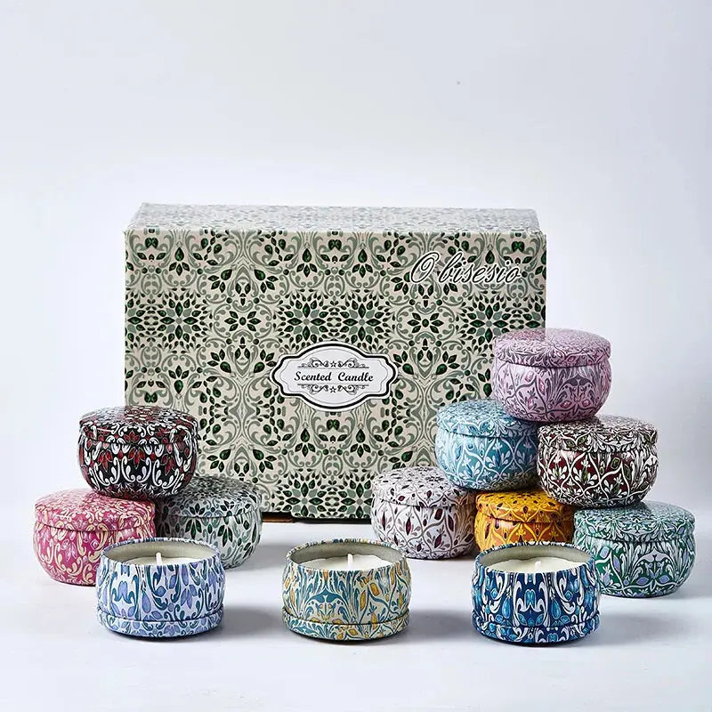 Set of colorful candles with decorative lids and a patterned box on a white background