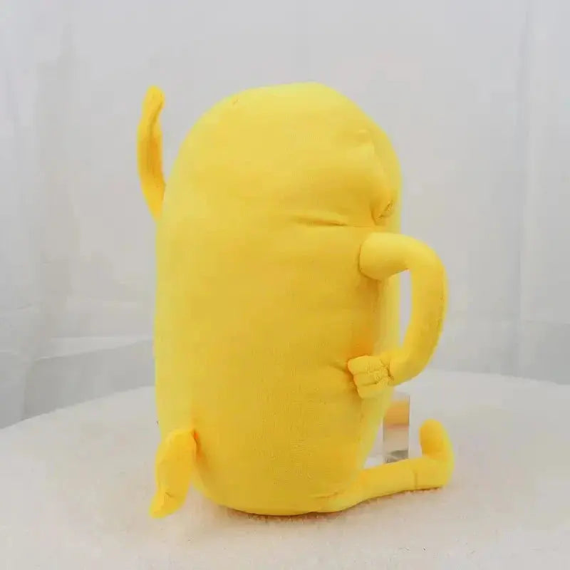 Yellow plush toy resembling a cat on a white surface with a white background