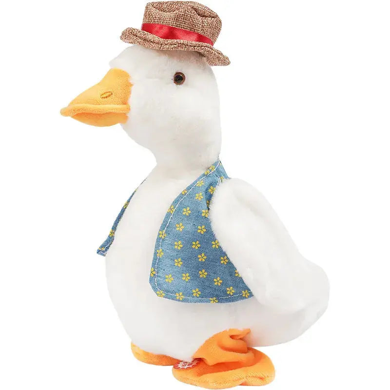 Stuffed duck toy wearing a hat and denim dress on a white background